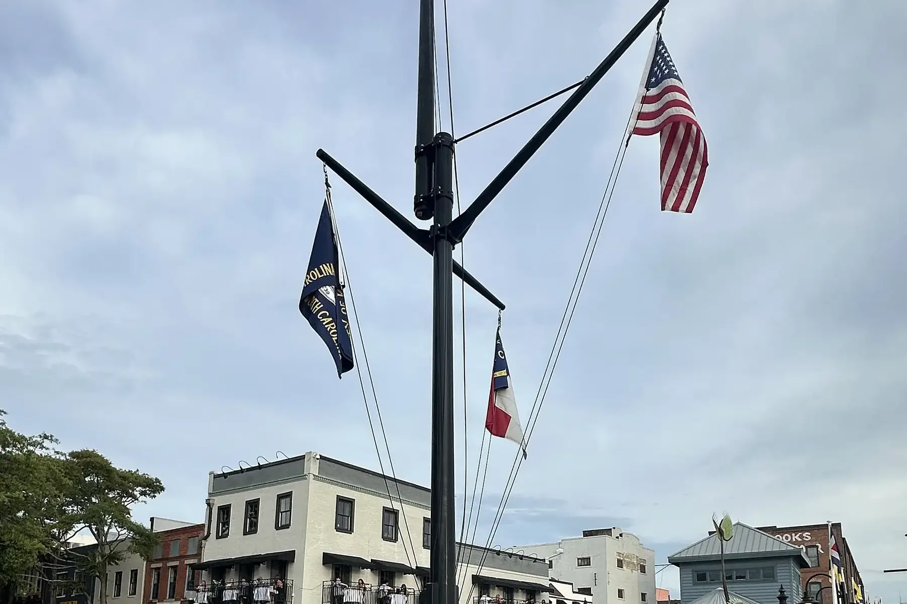 The U.S. and North Carolina flags fly over a plaza on the Riverwalk in downtown Wilmington.