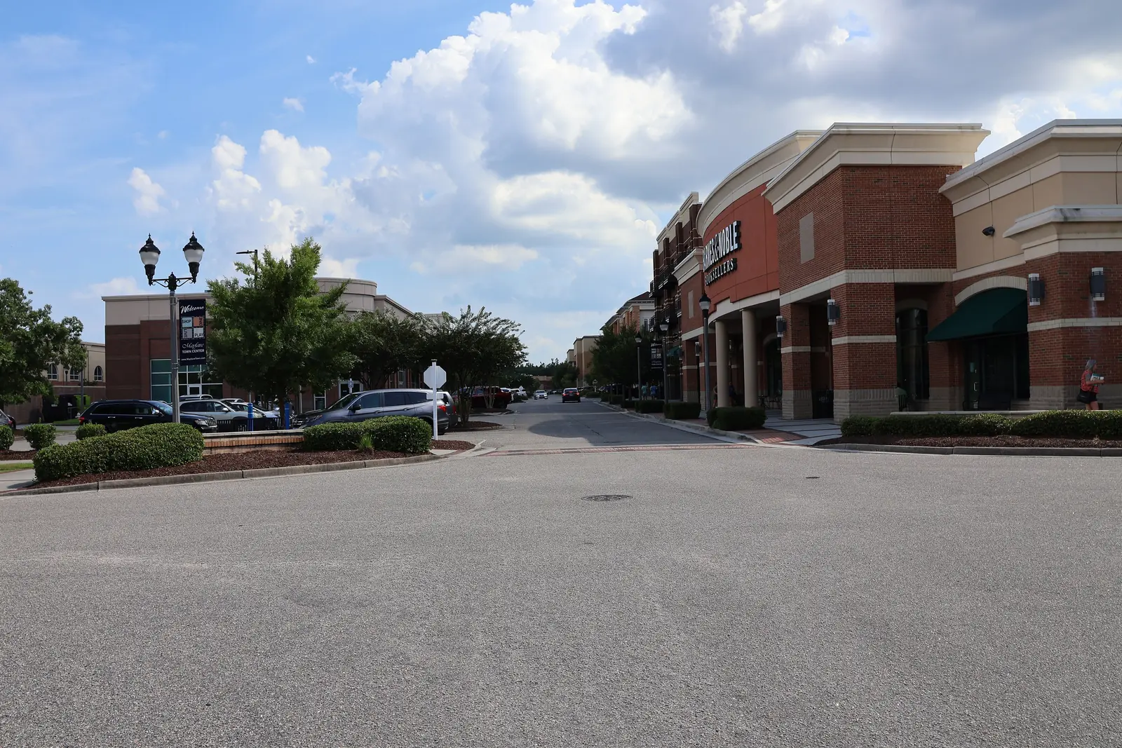 Brick storefronts and a parking lot along a street in Mayfaire, Wilmington.