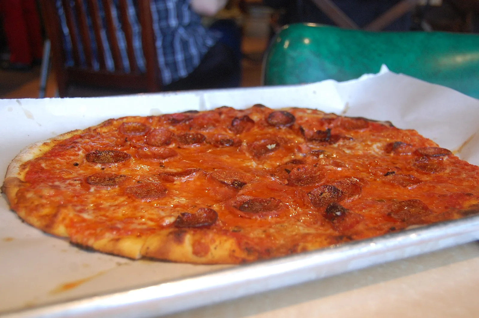 A thin-crust pepperoni pizza on a baking tray. The photo was not taken at a Wilmington restaurant.